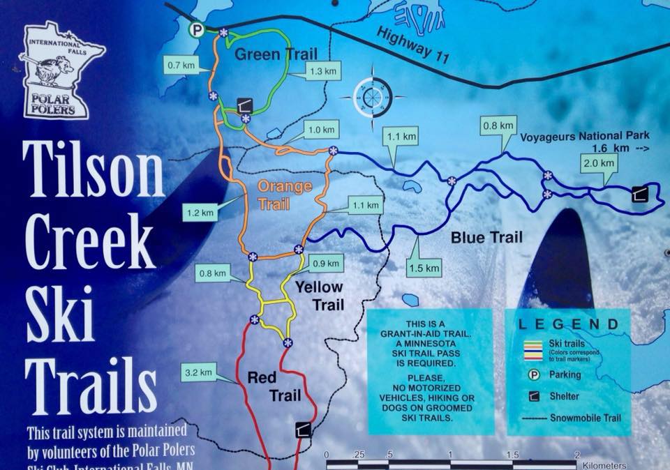A colorful trail map for Tilson Creek Ski Trails in Minnesota shows green, orange, yellow, blue, and red routes near Rainy Lake, with distances and a legend for ski trails, parking, shelter, and snowmobile trail bordering Voyageurs National Park. | Rainy Lake, MN