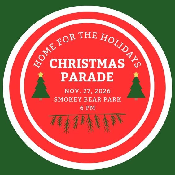 Red and white circular flyer with text: “Home for the Holidays Christmas Parade, Nov. 27, 2026, Smokey Bear Park, 6 PM.” Two Christmas trees and evergreen branches decorate the design. | Rainy Lake, MN